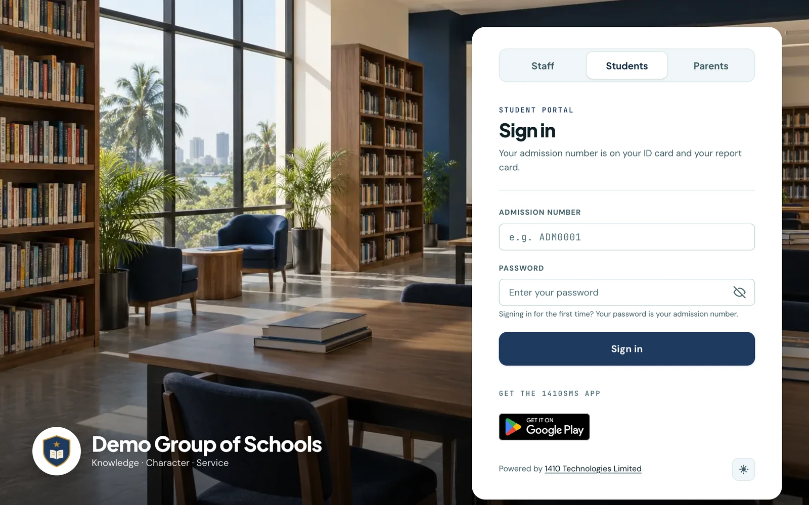 The student sign-in page of Demo Group of Schools in the floating card layout. A sunlit library with wooden reading tables, navy chairs and full bookshelves fills the page, with the school crest, name and motto as a caption in the lower left. A white card on the right holds the Staff, Students and Parents switch with Students pressed in, the student sign-in form asking for an admission number and password, and the Google Play badge.