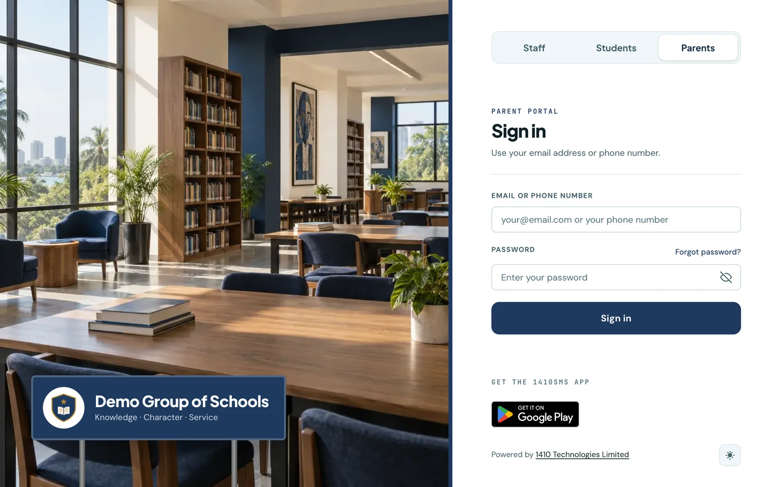 The parent sign-in page of Demo Group of Schools in the signboard layout. On the left, a photo of a sunlit school library with tall windows, bookshelves, wooden reading tables and navy chairs, with a navy signboard on two posts at its foot carrying the school crest, the name Demo Group of Schools and the motto Knowledge, Character, Service. On the right, a Staff, Students and Parents switch with Parents pressed in, then the Parent portal sign-in form with an email or phone number field, a password field and a Sign in button, and the Google Play badge below.