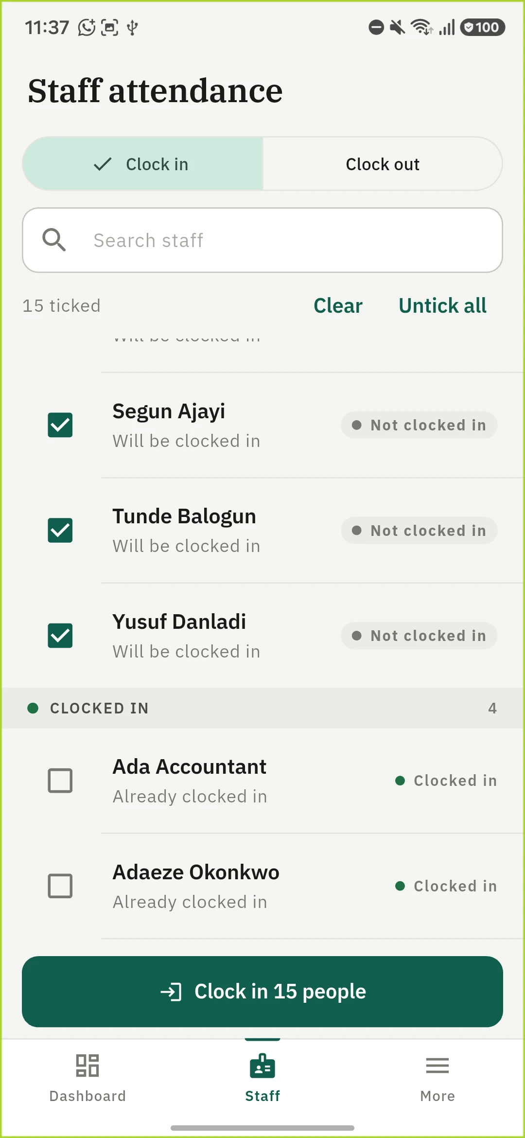 The 1410SMS Android app Staff attendance screen showing the roll call. A Clock in and Clock out toggle with Clock in selected, a Search staff box, and a line reading 15 ticked with Clear and Untick all beside it. The list below is ruled into two headed blocks. In the first, Segun Ajayi, Tunde Balogun and Yusuf Danladi are ticked, each reading Will be clocked in and marked Not clocked in. A heading reads CLOCKED IN, 4, and under it Ada Accountant and Adaeze Okonkwo are unticked, each reading Already clocked in and marked Clocked in in green. A full-width Clock in 15 people button sits at the foot of the screen.